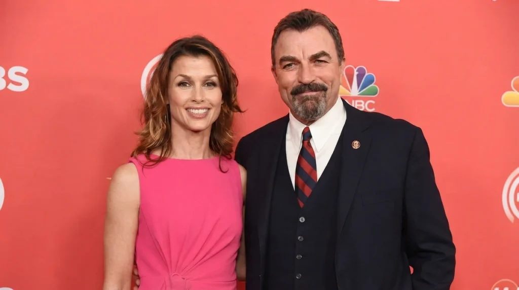 Bridget Moynahan smiling alongside her Blue Bloods co-star Tom Selleck at a red carpet event