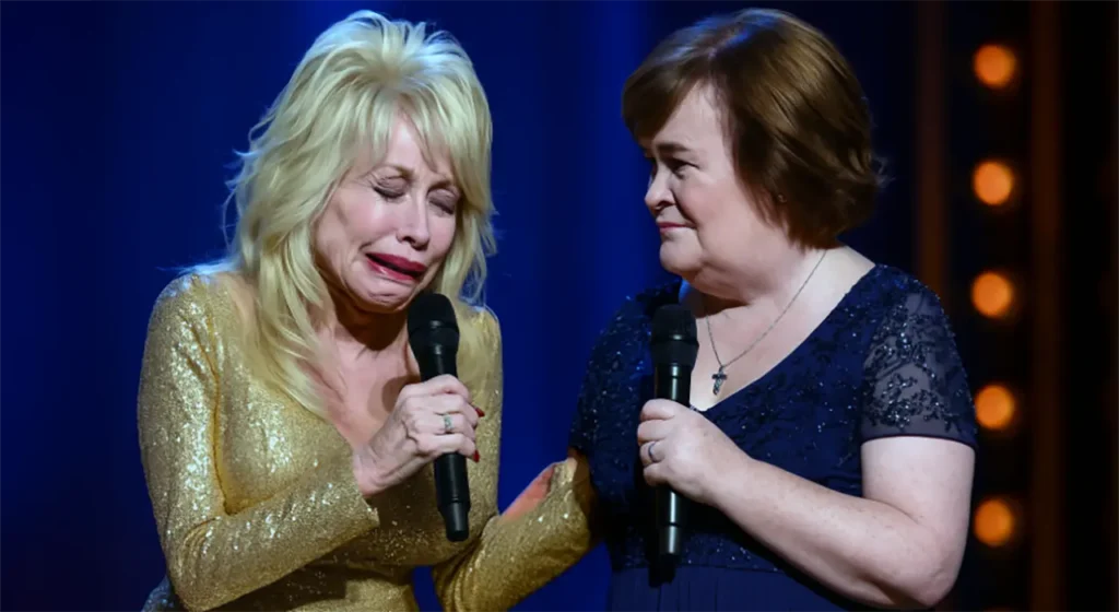 Dolly Parton breaks down in tears while Susan Boyle holds her hand during an emotional duet on stage.