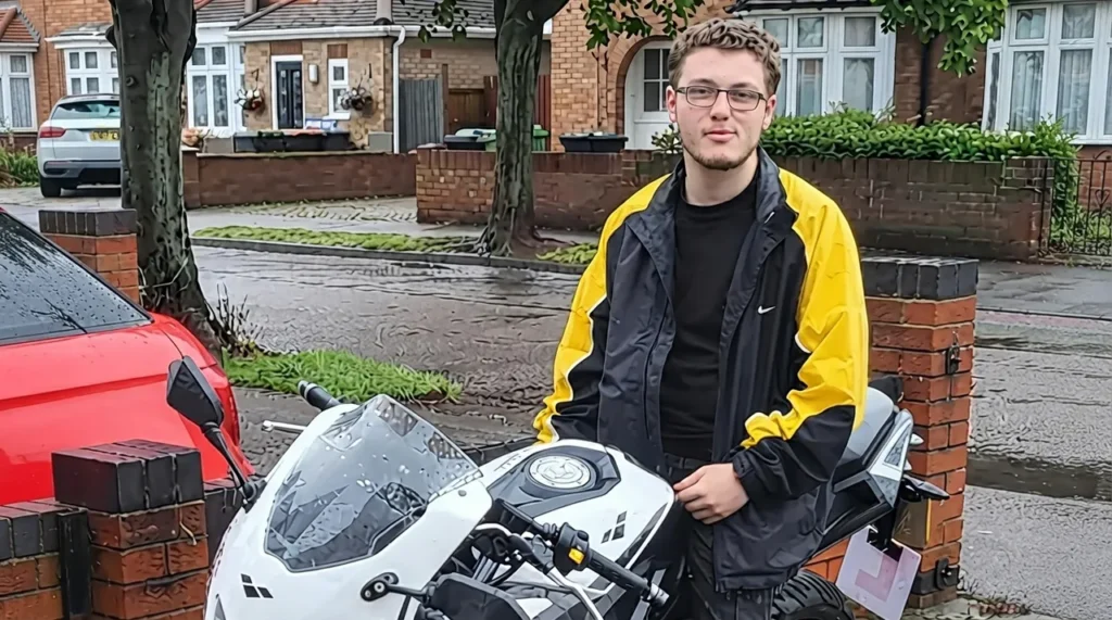 A candid portrait of 21-year-old artist Tyler Morton, sitting on his white motorcycle in Bedford, U.K., weeks before his death from a misdiagnosed glioblastoma.